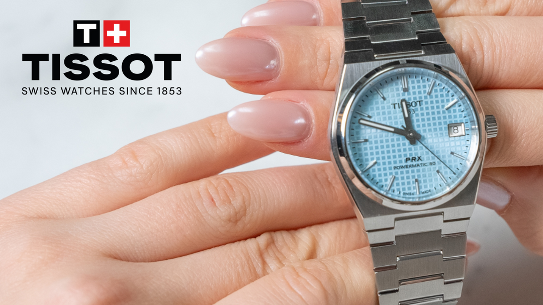 Tissot PRX Watch on woman model hands with white marble background by Orly Jewellers. Photo Credits : Solia Numérique Inc.